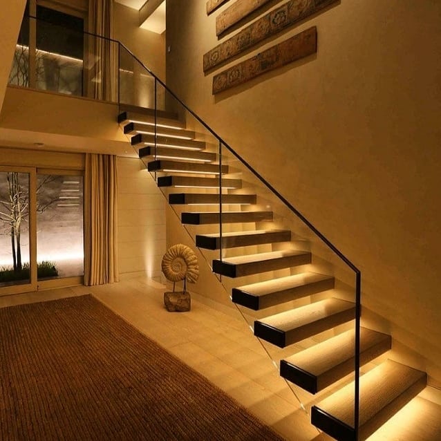 Wooded floating staircase with LED-lights and frameless glass balustrade