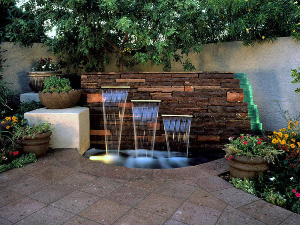 Modern-Backyard-water-fountain-design-paved-patio-brick-feature-wall-lighting
