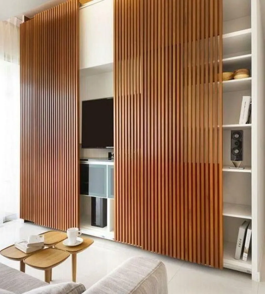 This wooden decorative wall paneling also works to hide the shelves and media unit