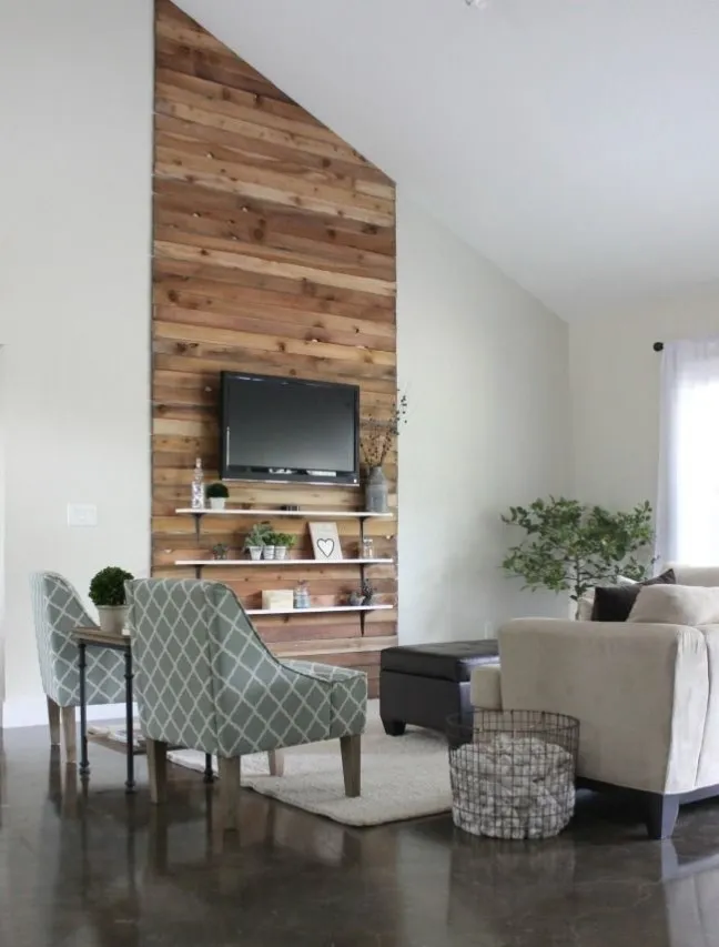 Loft Living Room with Feature Wall That Doubles as Media Unit with Shelves