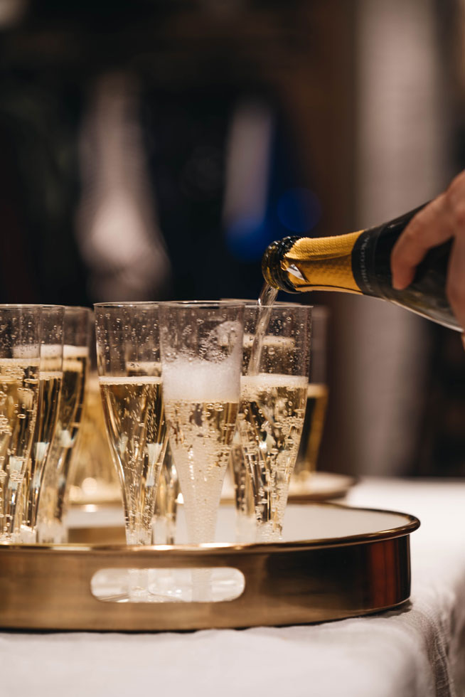 Champagne poured in to flutes on a tray Champagne poured in to flutes on a tray