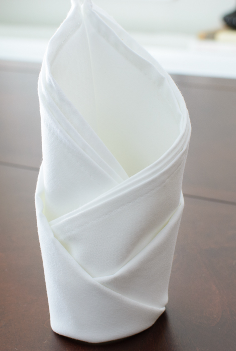 Rosebud napkin fold in a white napkin