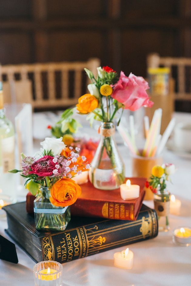 Vintage books centerpiece with flowers and tea light candles