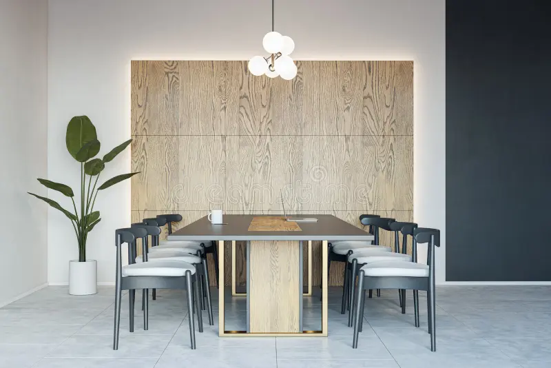 Side view dark stylish conference table surrounded black chairs with backlit wooden wall as backdrop