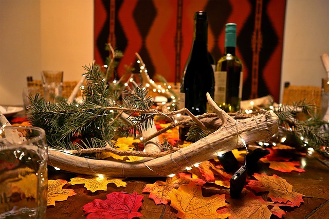 A rustic dinner table with wine bottles