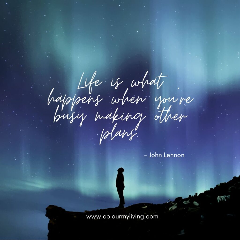 Image: Sillouhette of a man against a background of northern lights. Quote: John Lennon - Life is what happens when you’re busy making other plans.